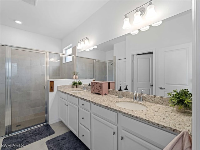 bathroom featuring tile patterned floors, vanity, and walk in shower