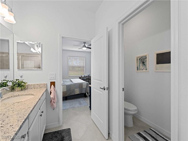 bathroom featuring tile patterned floors, ceiling fan, vanity, and toilet