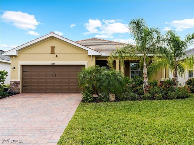 single story home featuring a front yard and a garage