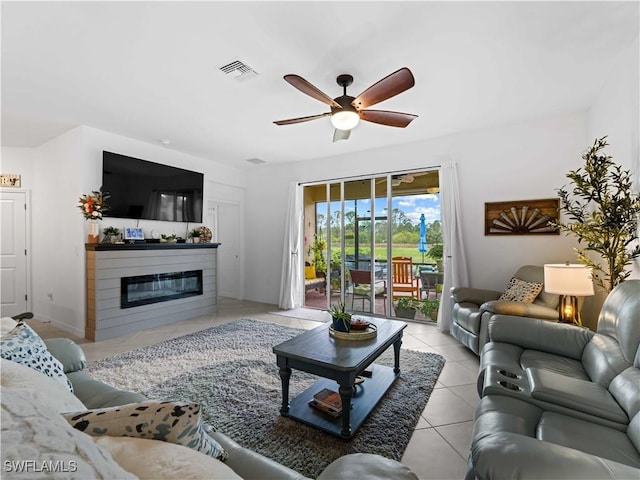 living room with ceiling fan and light tile patterned floors