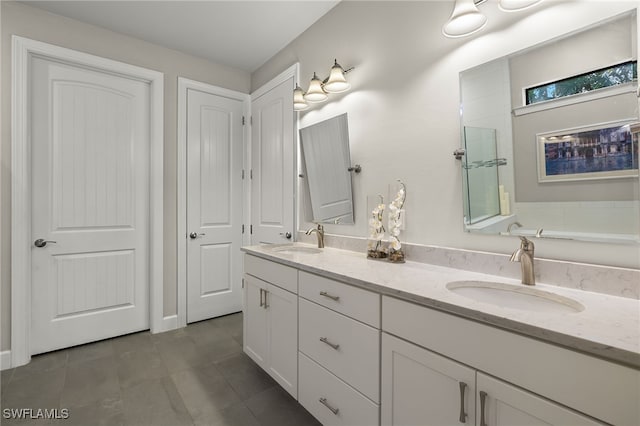 bathroom with tile patterned floors and vanity