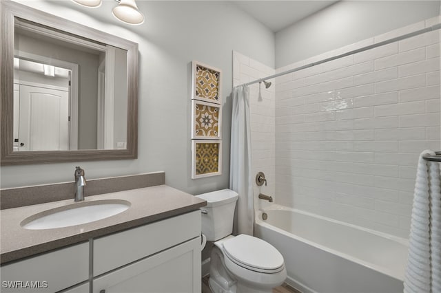 full bathroom with vanity, shower / tub combo, and toilet