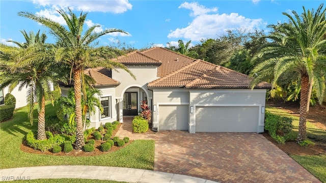 mediterranean / spanish-style house with a garage