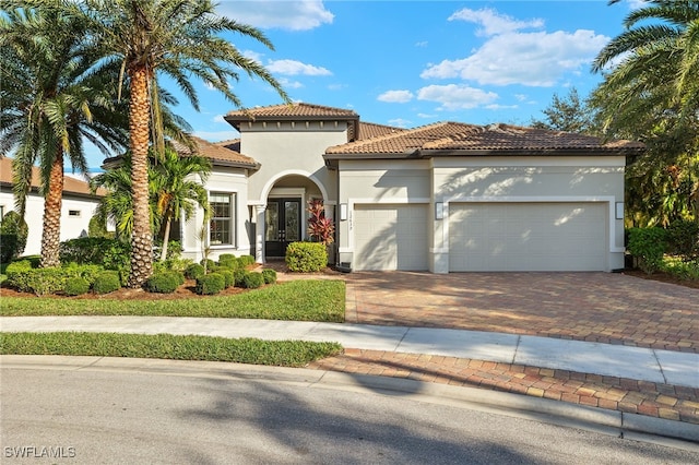 mediterranean / spanish house featuring a garage