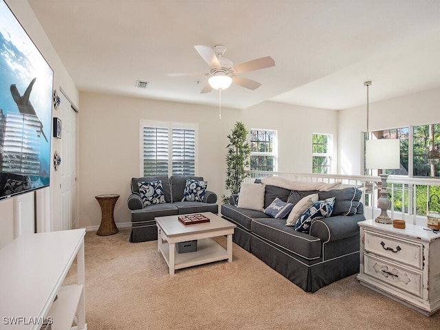 carpeted living room featuring ceiling fan