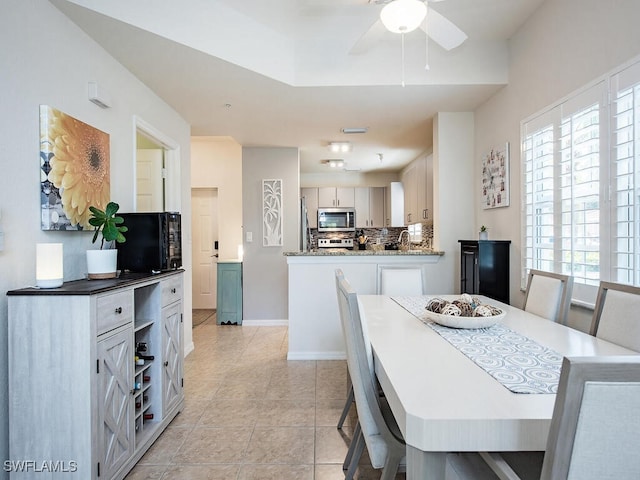 tiled dining room with ceiling fan