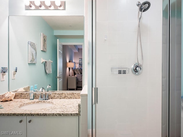 bathroom with walk in shower and vanity