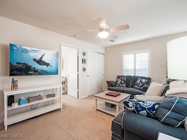 living room with light colored carpet and ceiling fan