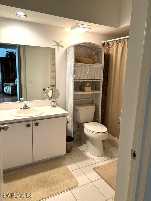 bathroom with vanity, a shower with shower curtain, tile patterned floors, and toilet