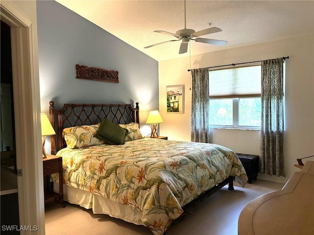 carpeted bedroom with ceiling fan and lofted ceiling