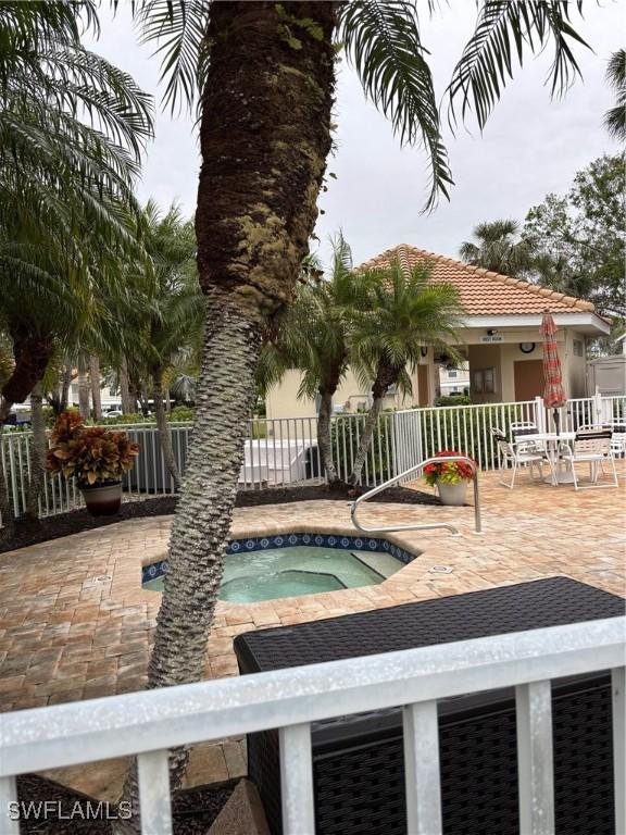 view of swimming pool featuring a patio area and a hot tub