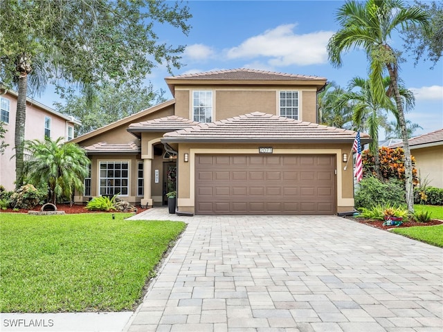 view of front of property with a garage and a front lawn