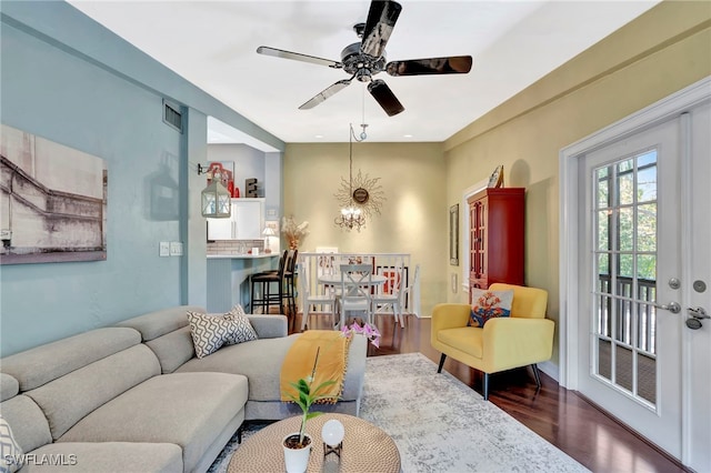 2511 Estey Ave Unit E4, Naples, FL 34104 - living area with wood finished floors, a ceiling fan, and a chandelier