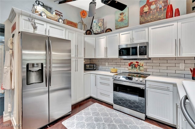 2511 Estey Ave Unit E4, Naples, FL 34104 - kitchen with appliances with stainless steel finishes, light countertops, white cabinets, and decorative backsplash