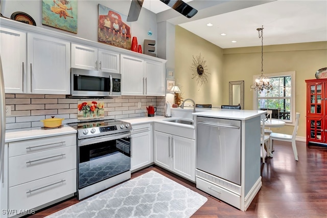 2511 Estey Ave Unit E4, Naples, FL 34104 - kitchen featuring stainless steel appliances, a peninsula, light countertops, backsplash, and recessed lighting