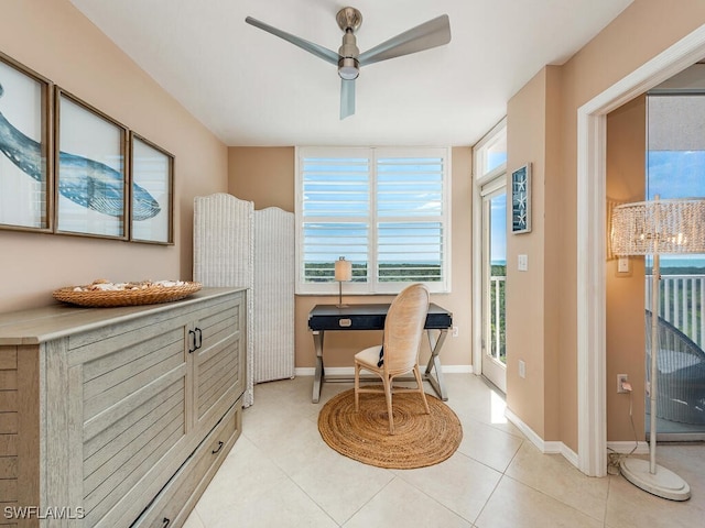 living area with ceiling fan and light tile patterned flooring