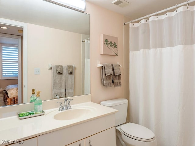 bathroom featuring vanity and toilet