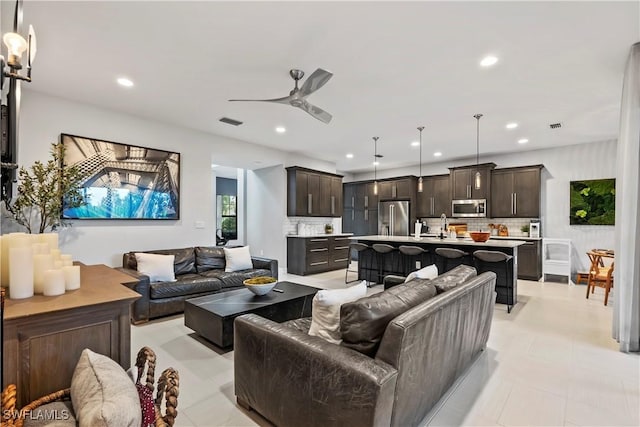 living room with ceiling fan and sink