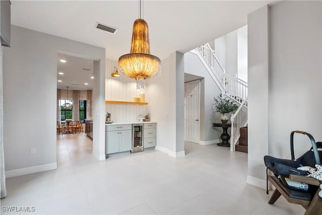 interior space with pendant lighting and wine cooler