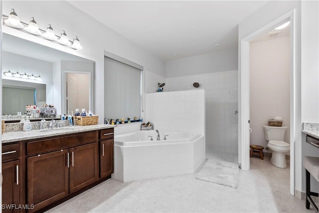 full bathroom with vanity, separate shower and tub, and toilet