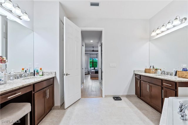 bathroom featuring ceiling fan, tile patterned flooring, and vanity