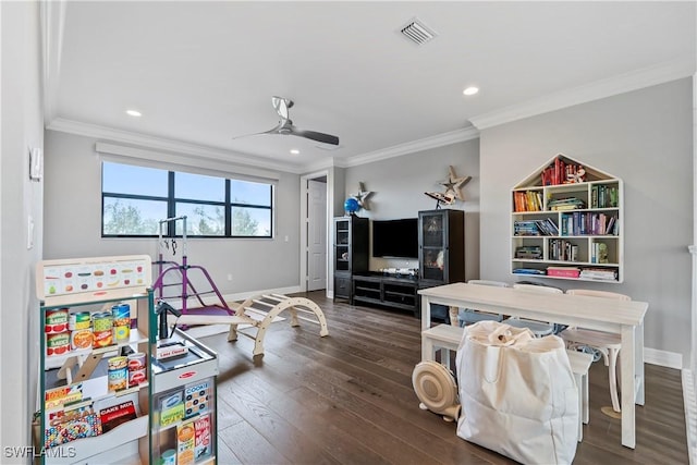 playroom featuring dark hardwood / wood-style flooring, ceiling fan, and crown molding