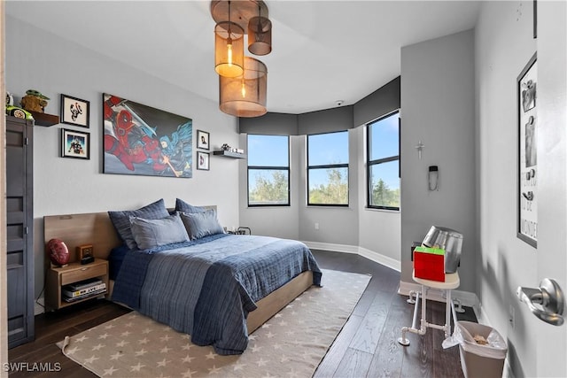 bedroom with dark wood-type flooring