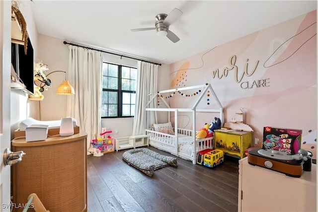 bedroom featuring a crib and dark hardwood / wood-style floors