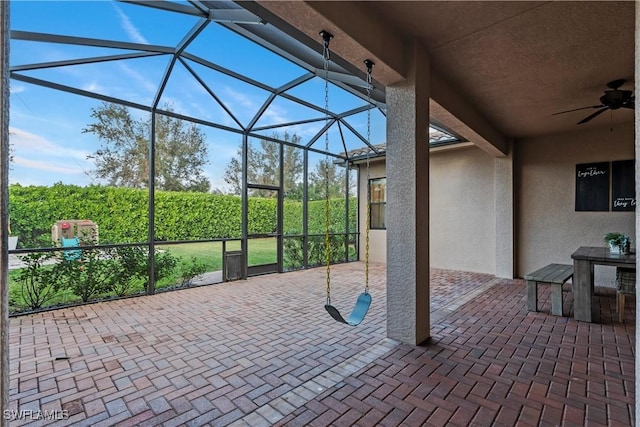 view of patio with ceiling fan and a lanai