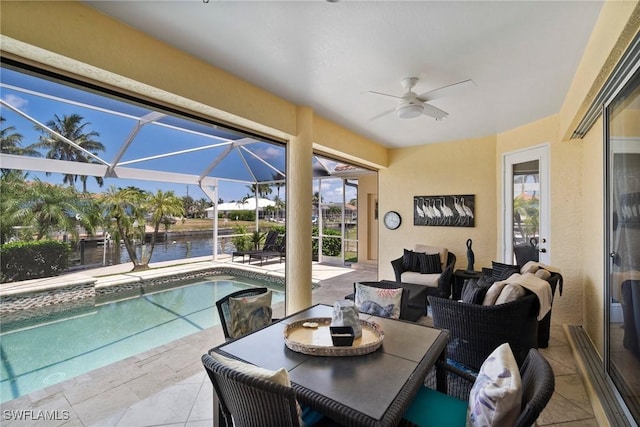 view of swimming pool featuring ceiling fan and a water view