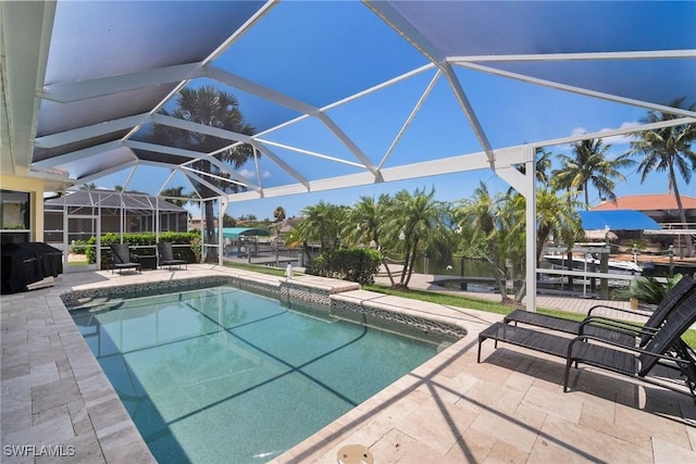 view of pool with a lanai, a grill, and a patio