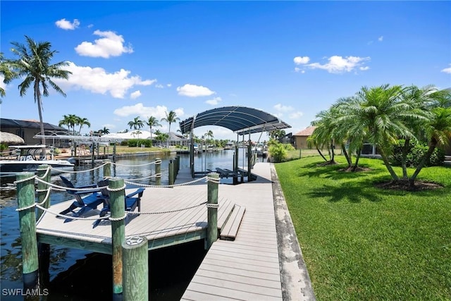 view of dock featuring a yard and a water view