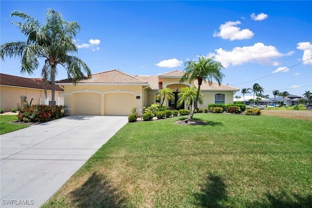 mediterranean / spanish home featuring a garage and a front yard