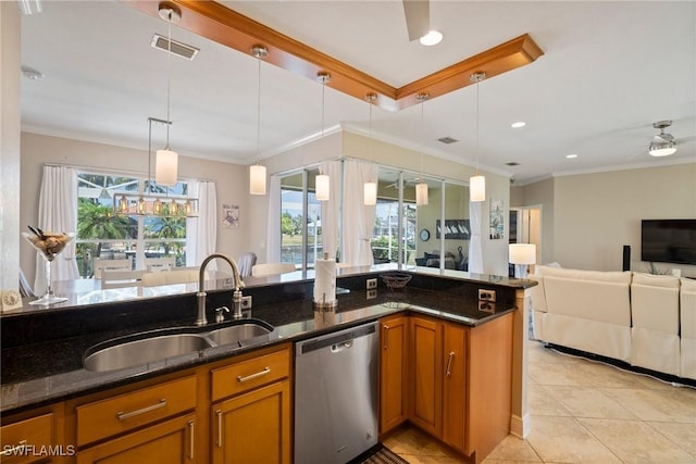 kitchen featuring stainless steel dishwasher, pendant lighting, dark stone countertops, and sink