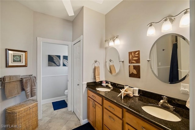 bathroom featuring tile patterned flooring, vanity, and toilet