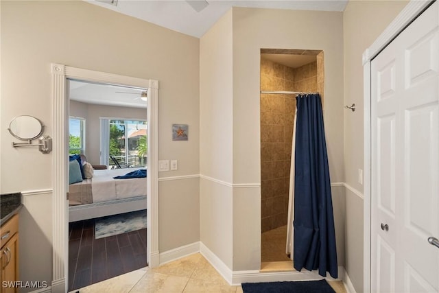 bathroom with curtained shower, tile patterned flooring, vanity, and ceiling fan