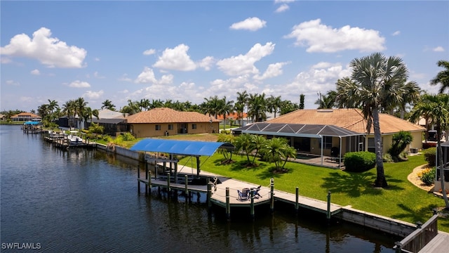 dock area featuring a lawn, glass enclosure, and a water view