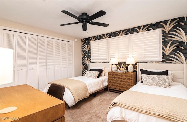 bedroom with ceiling fan, carpet floors, and a closet