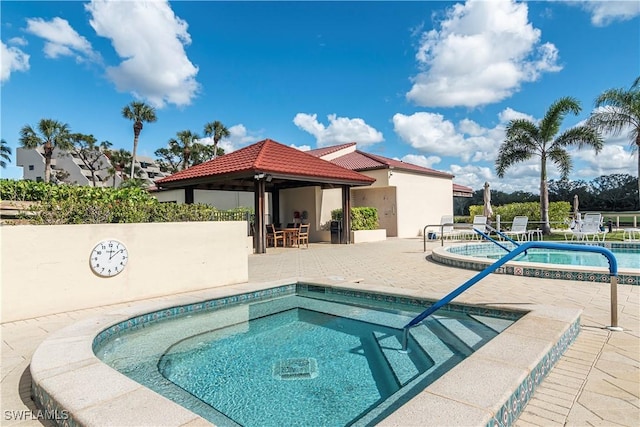 view of pool with a patio area, a gazebo, and a hot tub