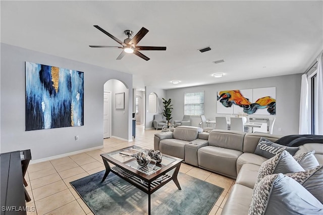 tiled living room with ceiling fan