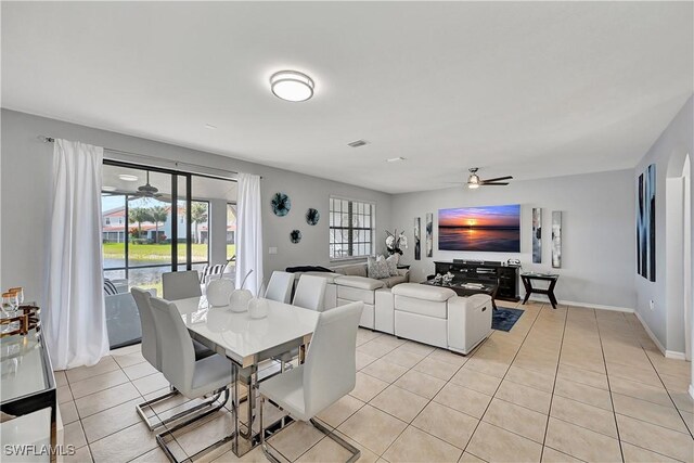 dining area with ceiling fan and light tile patterned flooring