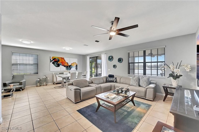 tiled living room featuring a wealth of natural light and ceiling fan