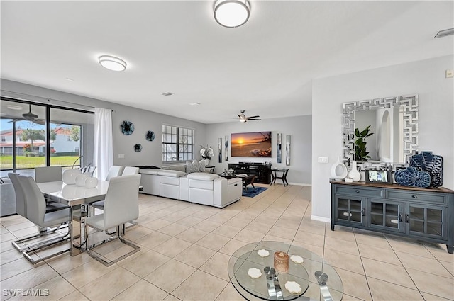 dining space with ceiling fan and light tile patterned flooring