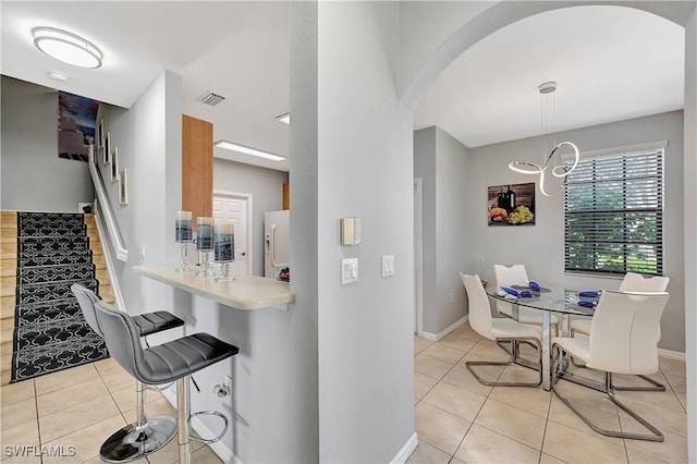 kitchen with light tile patterned flooring and hanging light fixtures