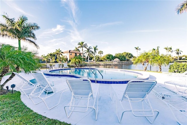 view of pool featuring a water view