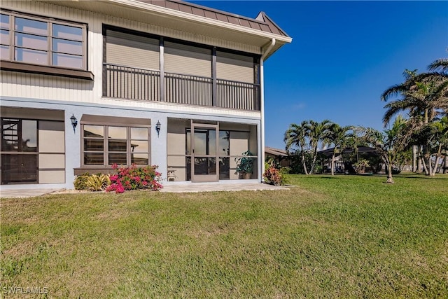 rear view of property with a yard