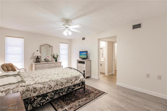 bedroom with ensuite bath, ceiling fan, and light wood-type flooring