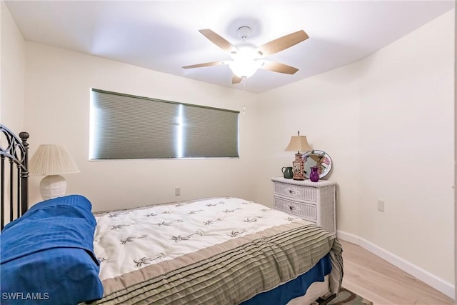 bedroom with ceiling fan and light hardwood / wood-style floors