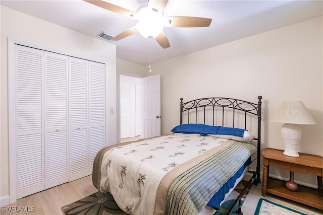 bedroom featuring light hardwood / wood-style flooring, a closet, and ceiling fan