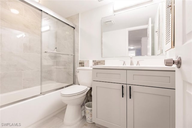 full bathroom with shower / bath combination with glass door, vanity, and toilet